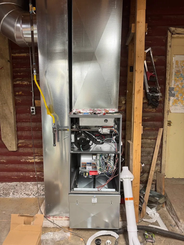 New high-efficiency furnace and plenum installed in a utility room