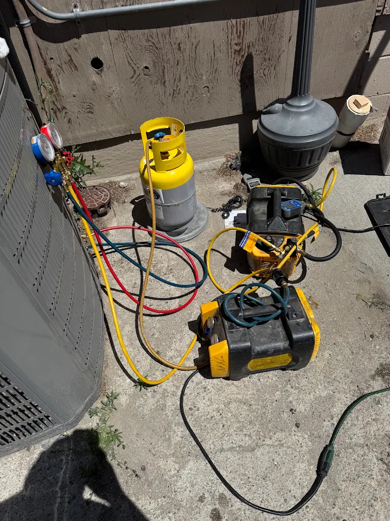 Recovery machine, vacuum pump and gauges set at an AC unit